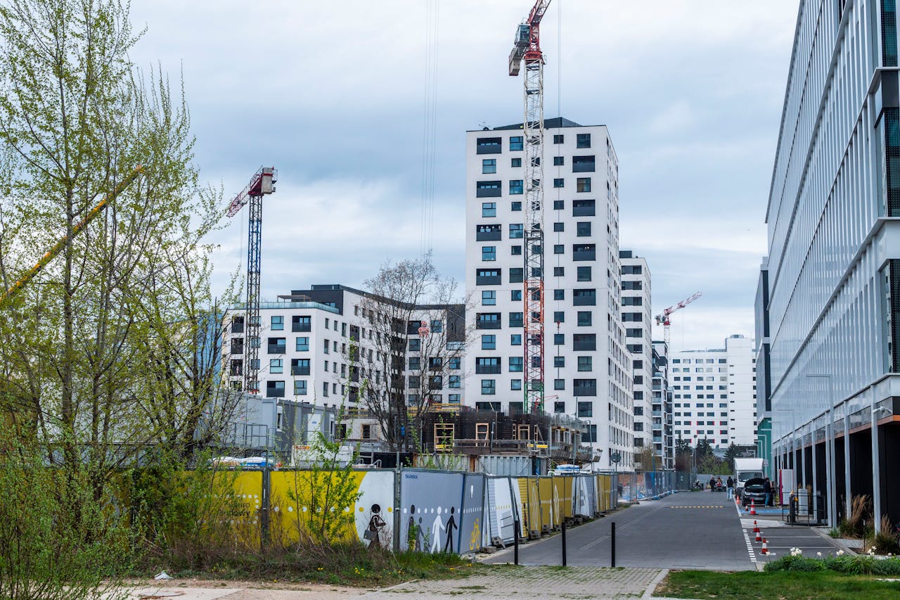 embark High-rise buildings and cranes in an urban construction site. Modern architecture.